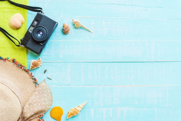 Beach accessories on bright blue pastel wooden background for summer holiday