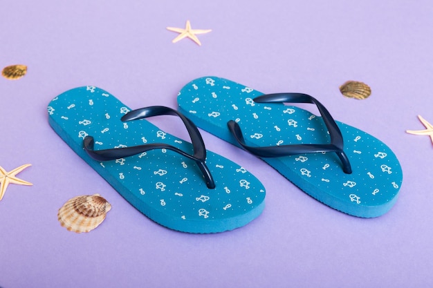 Beach accessories Flip flops and starfish on colored background Top view Mock up with copy space