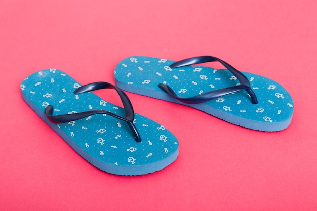 Beach accessories Flip flops and starfish on colored background Top view Mock up with copy space