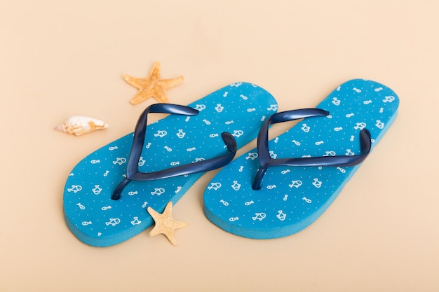 Beach accessories Flip flops and starfish on colored background Top view Mock up with copy space