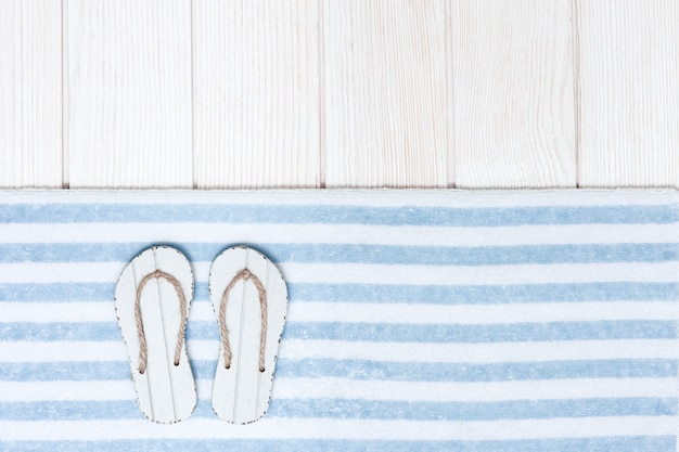 Beach accessories with flip-flops and cotton towel