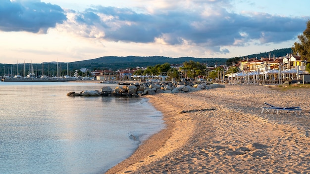 Beach on the Aegean sea coast of Greece in Skala Fourkas with rows of big rocks