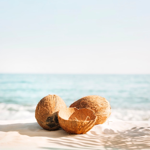 Beach background with three coconuts