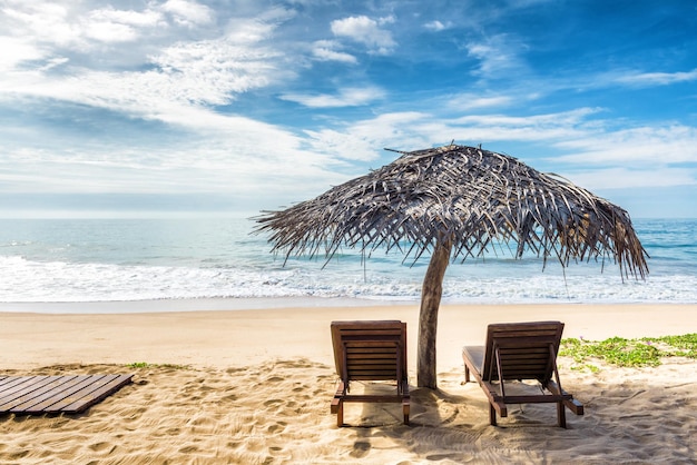 Beach beds with umbrella on the tropical beach