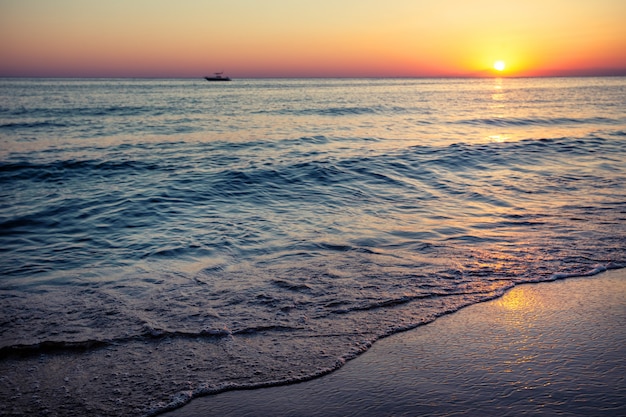 Beach by the sea at sunset