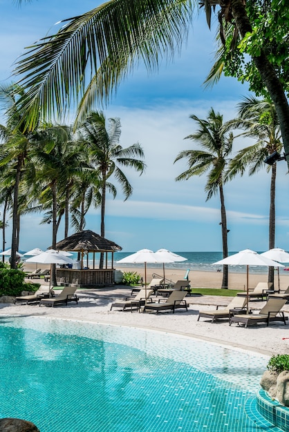 beach chair around swimming pool in hotel resort