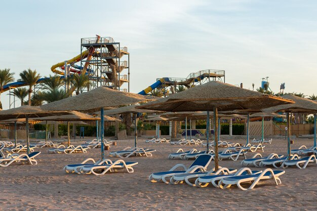 Beach coastline with deck chairs and umbrellas without people Deserted resort