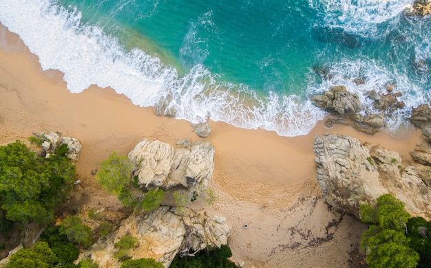 Beach full of rocks and waves in Spain