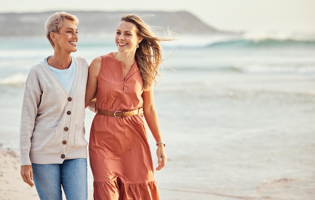 Beach happy and mother walking with her daughter for wellness exercise and bonding while on holiday Happiness smile and women embracing while on walk in nature by the ocean together in Australia