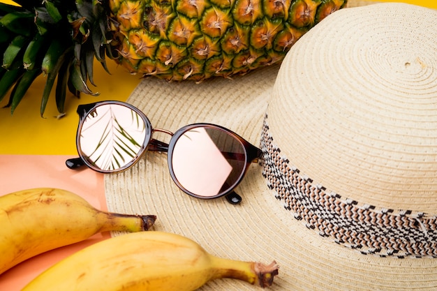 Beach hat and sunglasses for women, concept of relaxing summer vacations - close up.