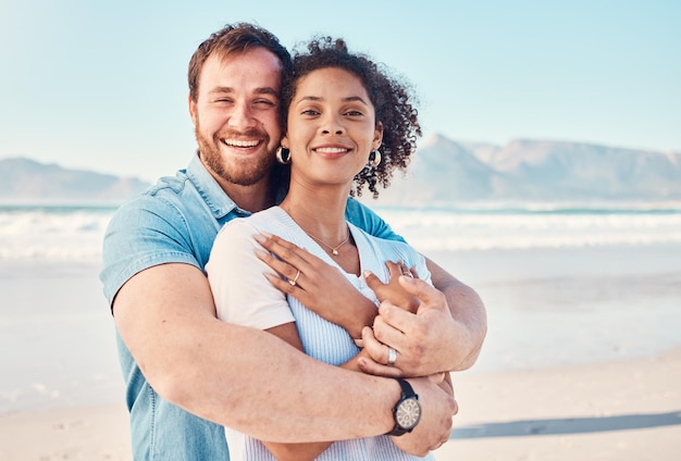 Beach love and portrait of couple hugging in nature holiday or romantic outdoor date together at the ocean sea or sand Happy smile and people in a hug embrace or happiness on anniversary