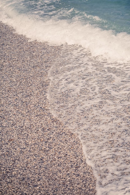 The beach of the Mediterranean coast with waves of azure water Summer sea breeze