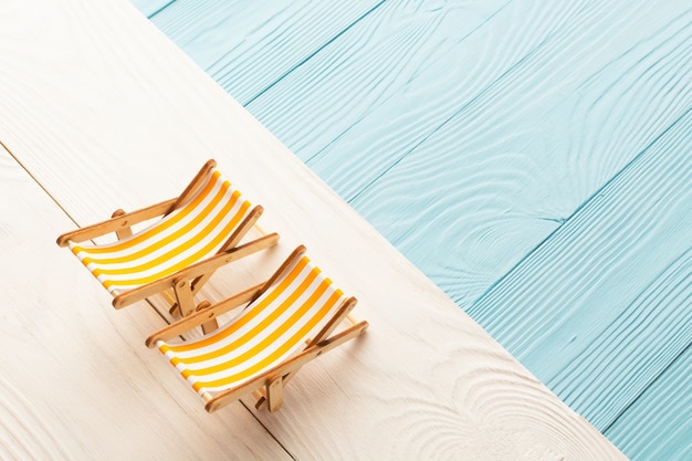 Beach miniature of colored wooden backgrounds and sun loungers