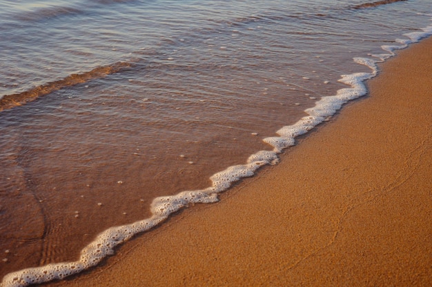 Beach in the morning Sand on the beach with a sea wave