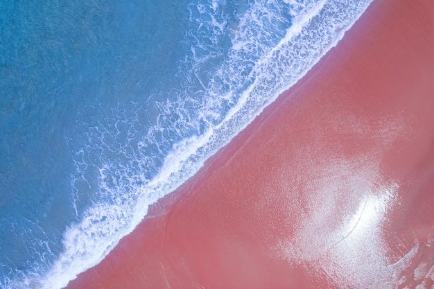 Beach Sand Sea Shore and waves white foamy summer sunny day backgroundAmazing beach top down view overhead seaside nature background