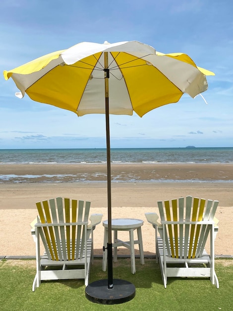 Beach umbrella and chairs on beach summer view background