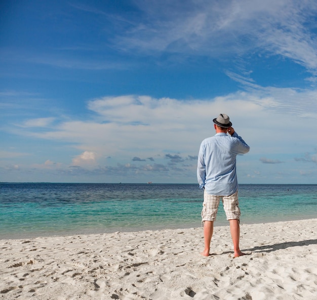 Beach vacation. Man and tropical beach in the Maldives.