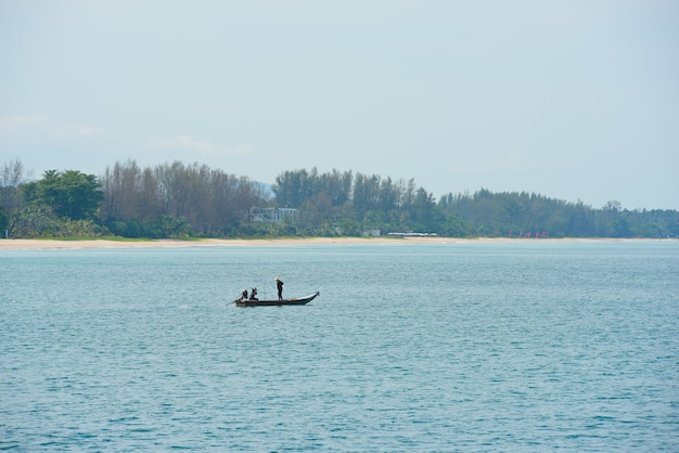 Beach view with pine trees And see the island with waves on a sunny day