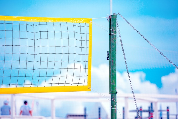 Beach Volleyball Game ball under sunlight and blue sky Volleyball net on the tropical beach