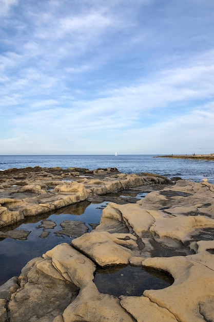 Beach with big rocks and calm sea