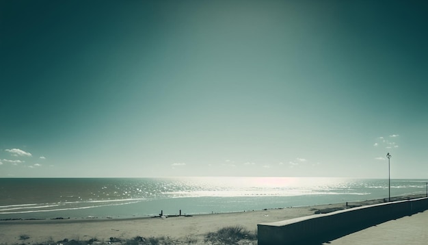 A beach with a blue sky and a beach and a bench