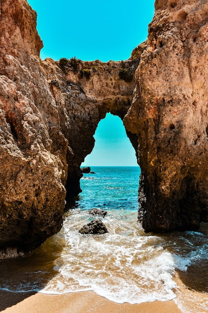 A beach with a blue sky and a sea view