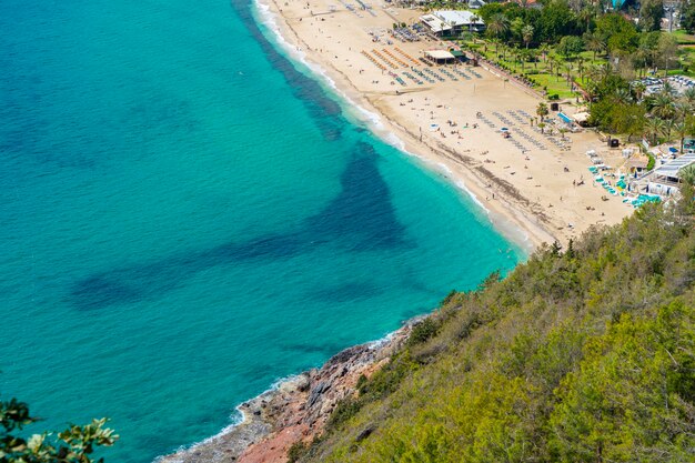 A beach with a blue water and a beach in the background