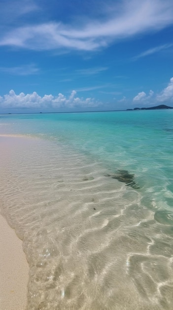 A beach with clear water and a blue sky