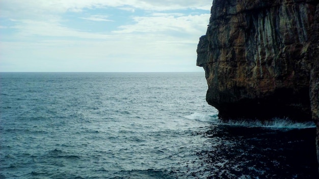 Beach with clear water and cliff