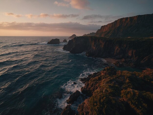 Photo a beach with a cliff and a beach with a sunset in the background