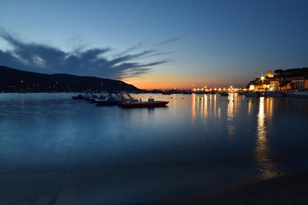 A beach with a lot of boats and lights on it