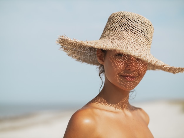 Beach woman in sun hat on vacation