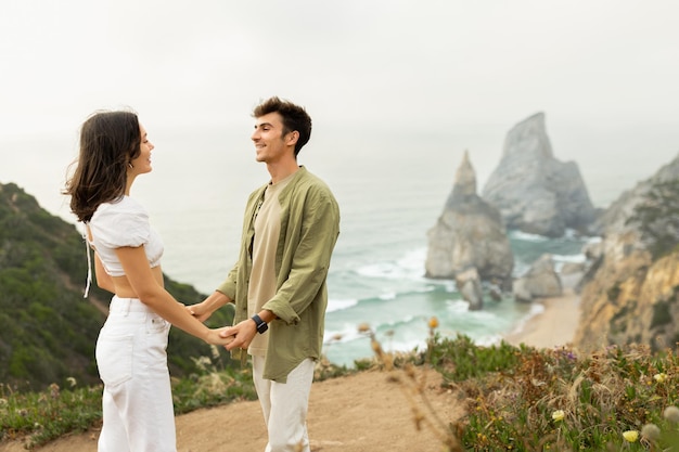 Beachside bonding young european couple in love having romantic date holding hands standing on