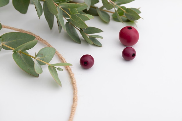 Beads and eucalyptus are close up The process of creating a decorative autumn wreath