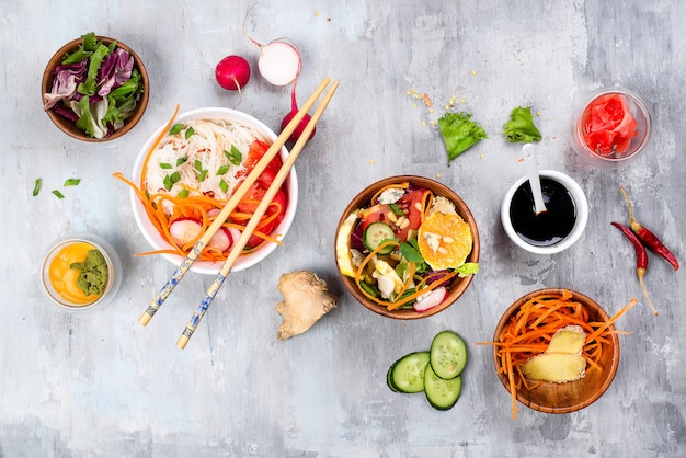 Bean thread noodles salad with cucumber and carrot, vegetarian salad on a plate on stone background