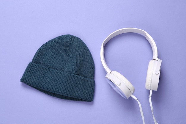 Beanie and stereo headphones on a purple background Youth party music concept