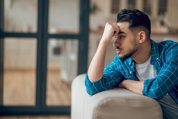 A bearded brunette looking upset and unhappy