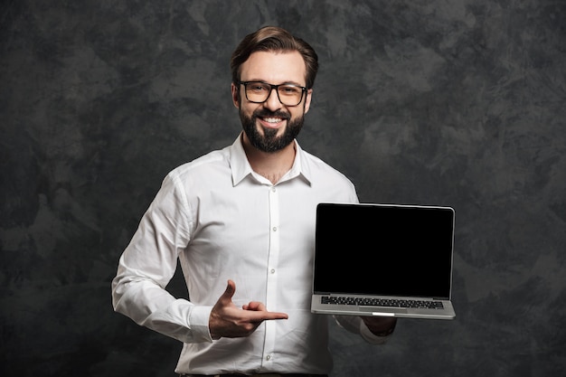 Bearded businessman showing display of laptop