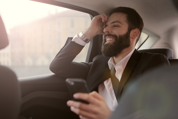 Bearded businessman traveling in a car