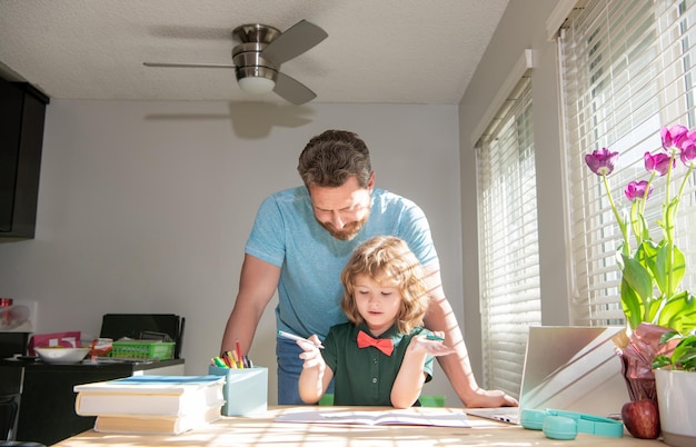 Bearded dad writing school homework with his boy son in classroom school lesson