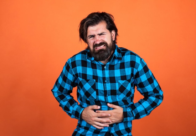 Bearded guy suffering from stomach ache has pain abdominal cavity medicine and health