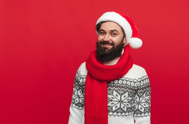 bearded hipster in Santa hat smiling