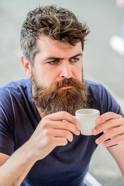 Bearded man in cafe. brutal male needs morning refreshment. drink espresso coffee. morning breakfast. Mature hipster with beard hair drinking coffee. Enjoying morning coffee.