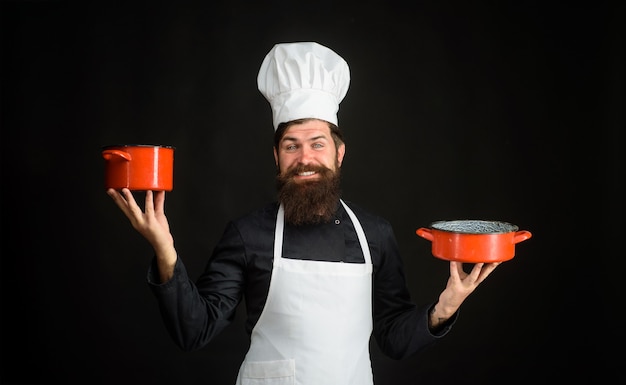 Bearded man cook wear chef hat and uniform cooking food profession professional chef man in cook hat