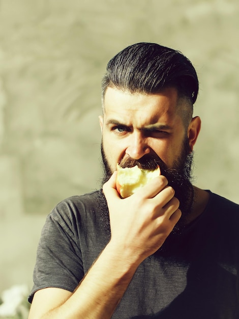 Bearded man eating apple