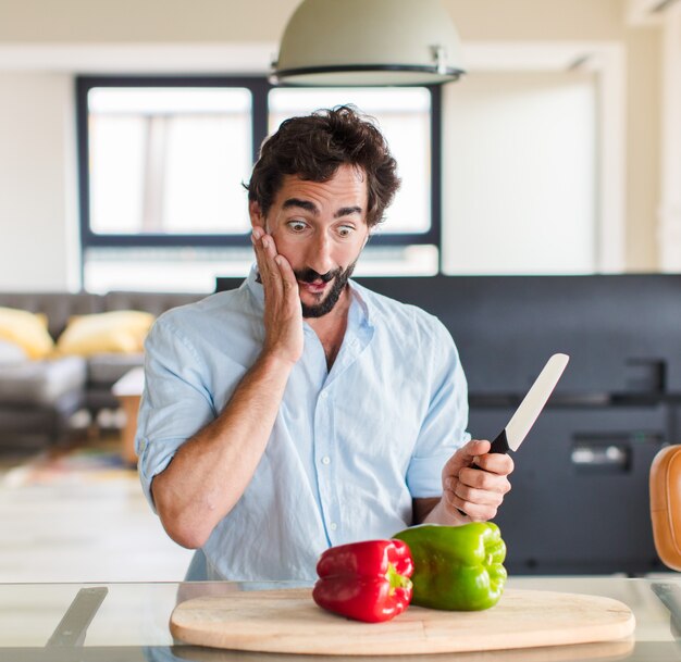 Bearded man feeling happy, excited and surprised, looking to the side with both hands on face