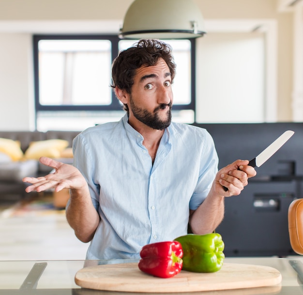 Bearded man feeling puzzled and confused, doubting, weighting or choosing different options with funny expression