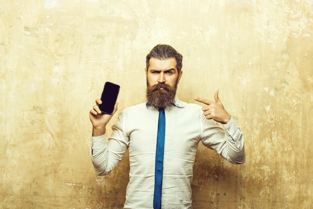 Bearded man or hipster with long beard hold phone