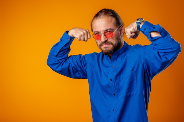 Bearded man in shirt showing bicep