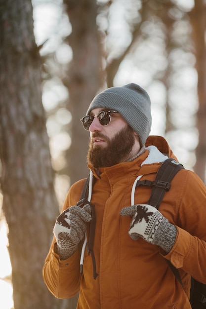 Bearded man trail hiking in a mountain forest